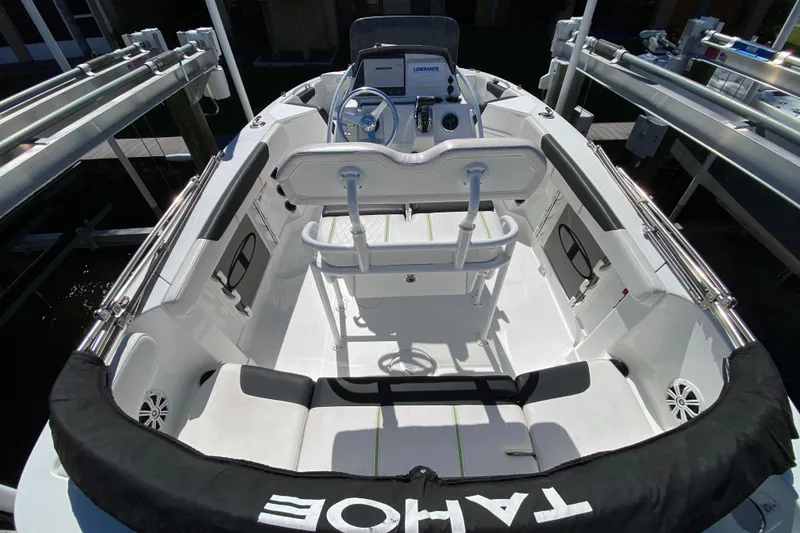 Slide: The Image of 2021 Tahoe 2150 CC boat interior with seating and steering console. - 38