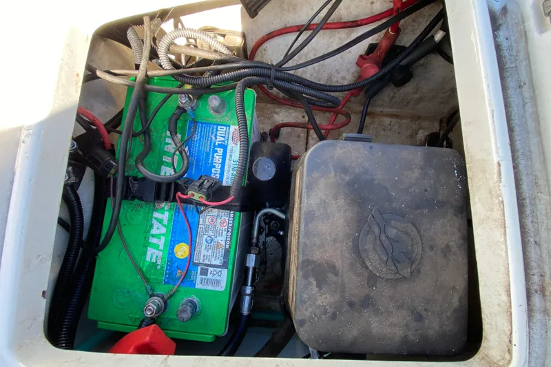 Slide: The Image of Battery compartment of a 2021 Tahoe 2150 CC boat with wiring and connections. - 43