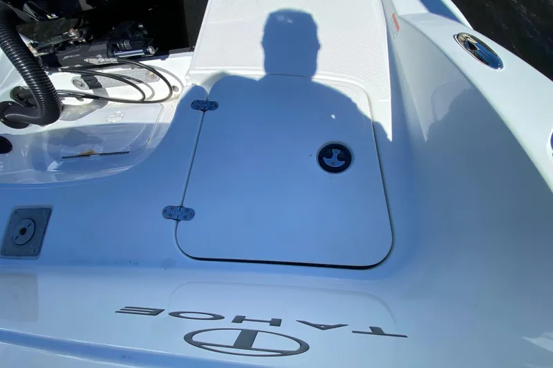 Slide: The Image of 2021 Tahoe 2150 CC boat deck with storage hatch and shadow. - 45