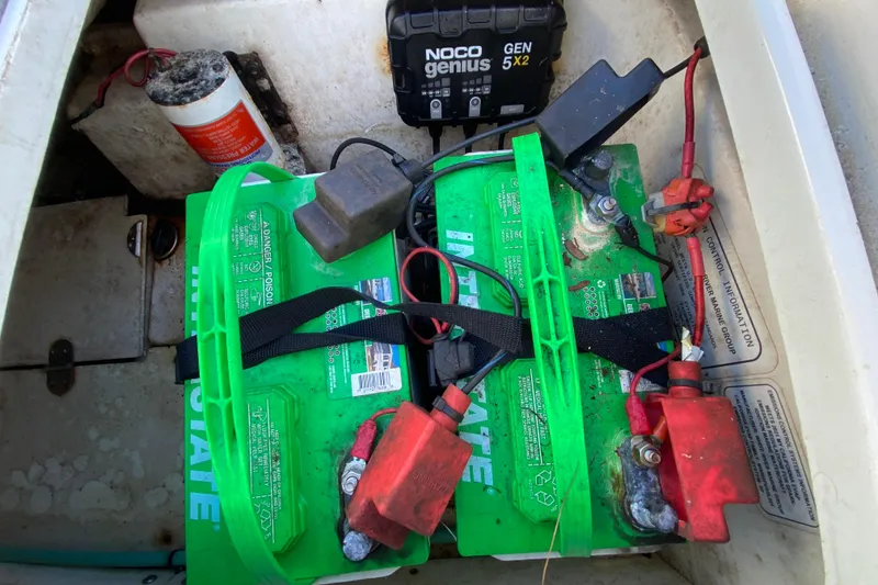 Slide: The Image of Battery compartment of a 2021 Tahoe 2150 CC boat with NOCO Genius charger. - 47
