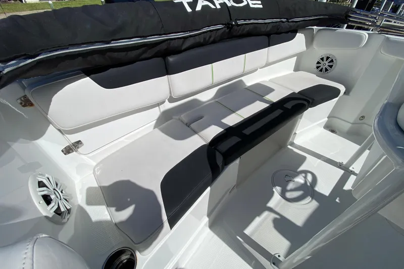 Slide: The Image of 2021 Tahoe 2150 CC boat interior with cushioned seating and speaker system. - 48