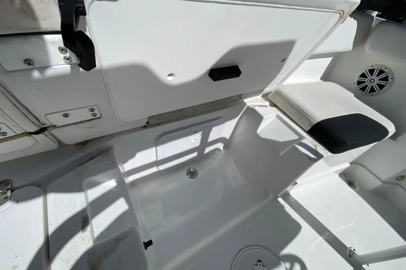Slide: The Image of 2021 Tahoe 2150 CC boat interior with storage compartments and seating. - 53