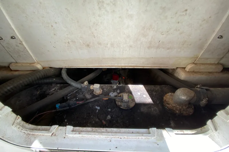 Slide: The Image of 2021 Tahoe 2150 CC boat interior showing mechanical components and wiring. - 54