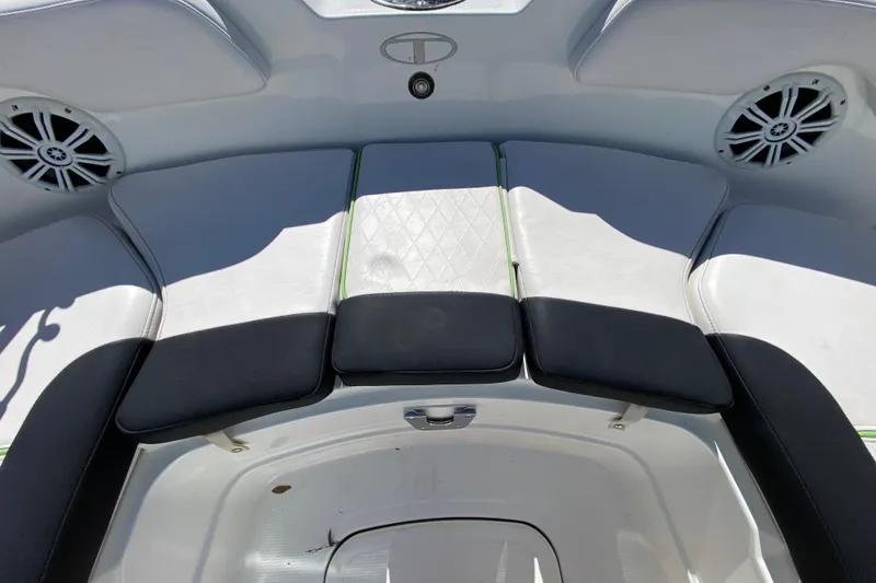 Slide: The Image of 2021 Tahoe 2150 CC boat interior with cushioned seating and speakers. - 55