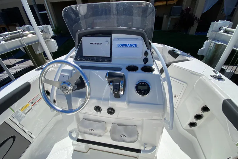 Slide: The Image of 2021 Tahoe 2150 CC boat console with steering wheel and navigation equipment. - 6
