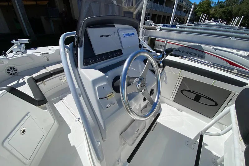 Slide: The Image of 2021 Tahoe 2150 CC boat interior with steering wheel and control panel. - 7
