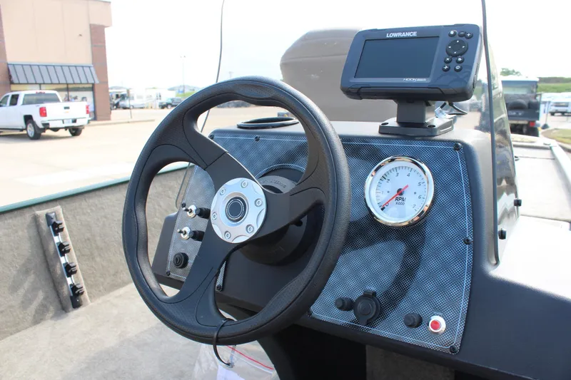 Slide: The Image of 2026 Tracker Bass Tracker Classic Limited dashboard with steering wheel and Lowrance fishfinder. - 7