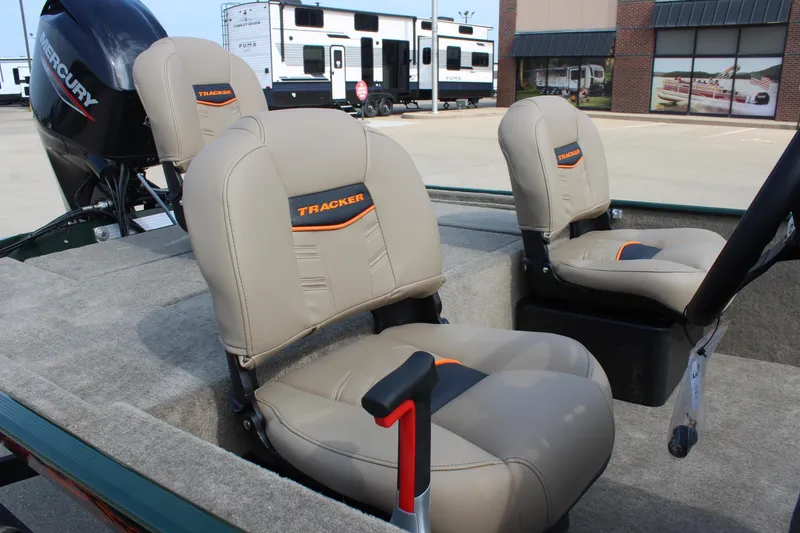 Slide: The Image of 2026 Tracker Bass Tracker Classic Limited boat seats with Mercury engine in parking lot. - 8