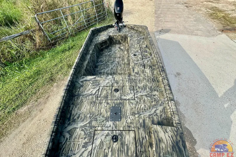 Slide: The Image of 2026 SeaArk 1752 Slayer X Pro boat with camouflage design on a sunny day. - 12