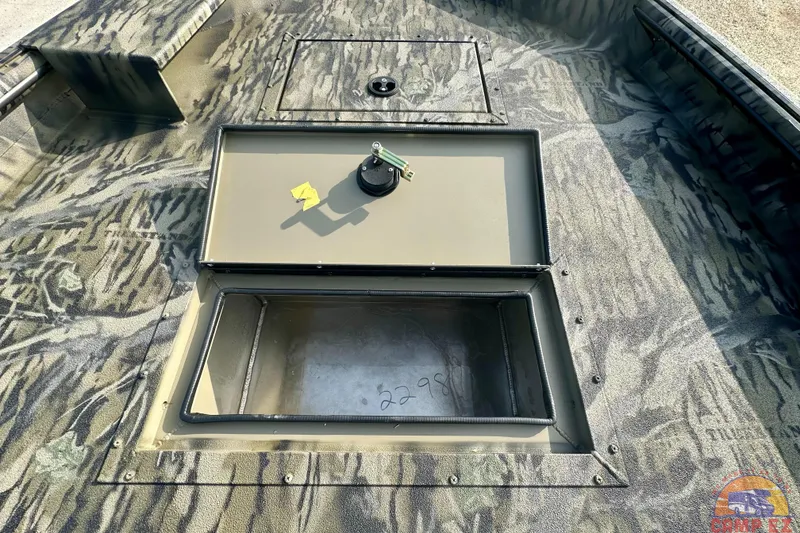 Slide: The Image of 2026 SeaArk 1752 Slayer X Pro boat interior with camo design and storage compartments. - 18