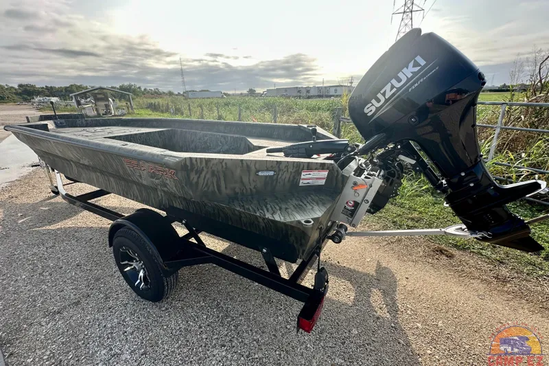 Slide: The Image of 2026 SeaArk 1752 Slayer X Pro boat with Suzuki outboard motor on trailer. - 2