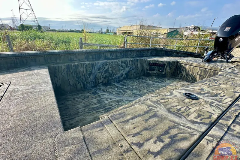 Slide: The Image of 2026 SeaArk 1752 Slayer X Pro boat with camouflage design, outdoor setting. - 20