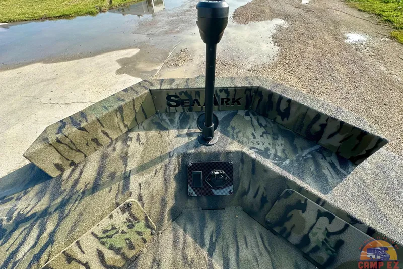 Slide: The Image of 2026 SeaArk 1752 Slayer X Pro boat with camouflage design on a wet surface. - 22