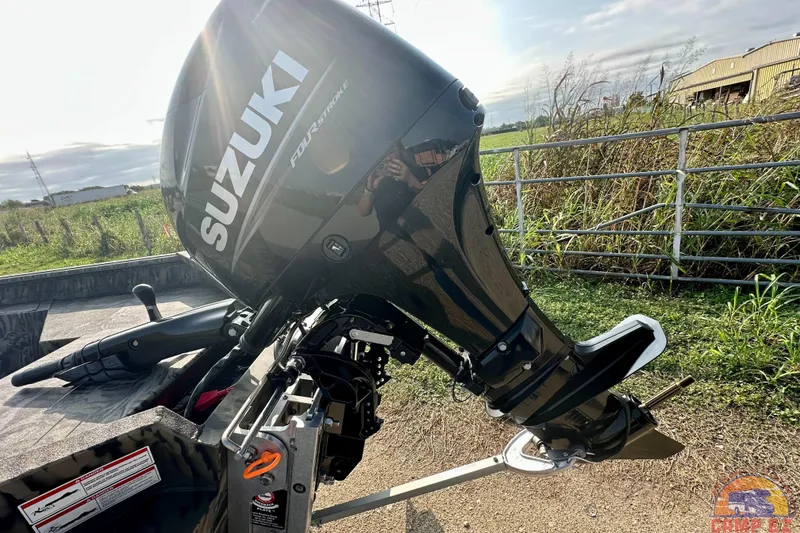 Slide: The Image of 2026 SeaArk 1752 Slayer X Pro with Suzuki four-stroke outboard motor in a rural setting. - 4