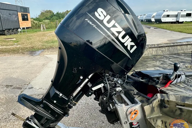 Slide: The Image of Outboard motor on 2026 SeaArk 1752 Slayer X Pro boat, parked near trailers. - 5