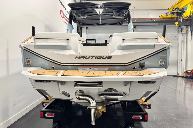 Slide: The Image of 2026 Nautique Super Air Nautique G23 Paragon boat rear view in showroom. - 3