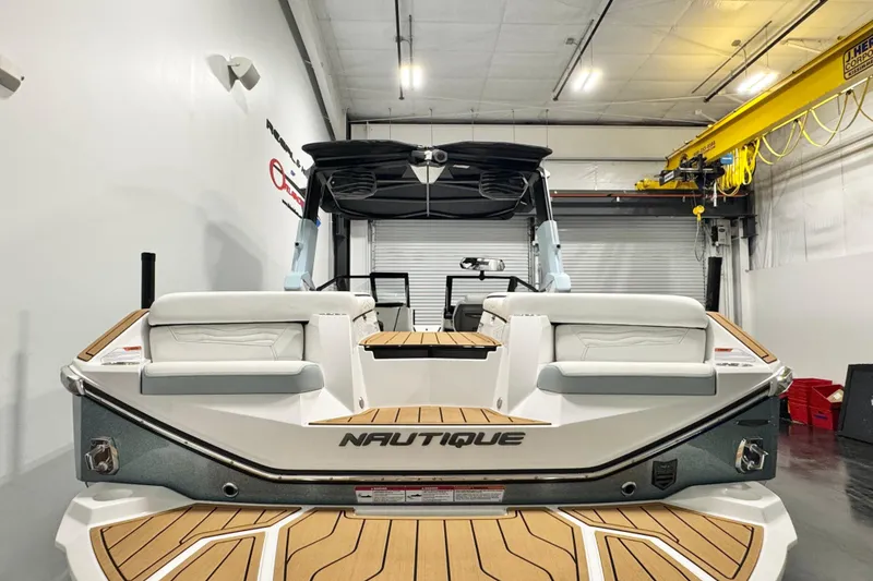 Slide: The Image of 2026 Nautique Super Air Nautique G23 Paragon in a showroom, rear view. - 4
