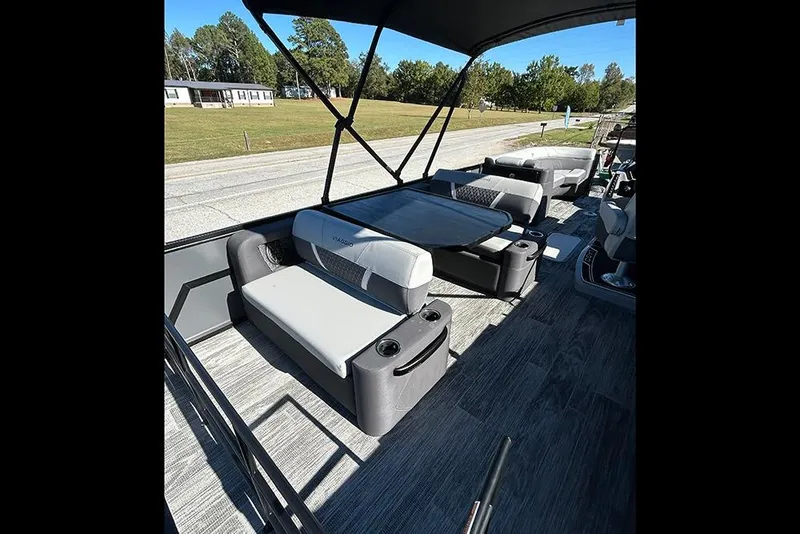 Slide: The Image of 2025 Viaggio Z22D boat interior with modern seating and table, set against a scenic backdrop. - 11