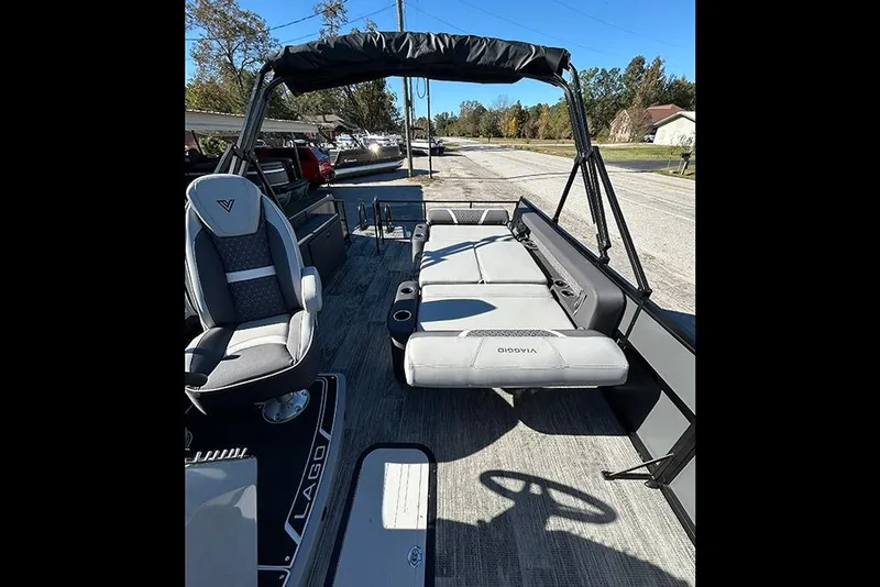 Slide: The Image of 2025 Viaggio Z22D boat interior with seating and steering wheel, parked on a sunny day. - 14