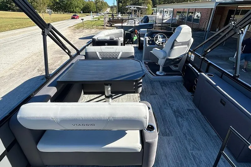Slide: The Image of 2025 Viaggio Z22D pontoon boat interior with seating and steering console. - 22