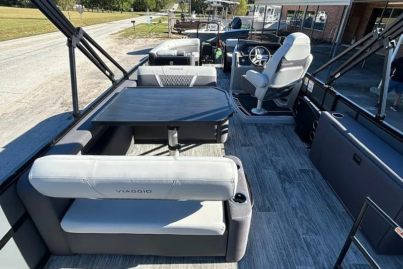 Slide: The Image of 2025 Viaggio Z22D pontoon boat interior with seating and steering console. - 23