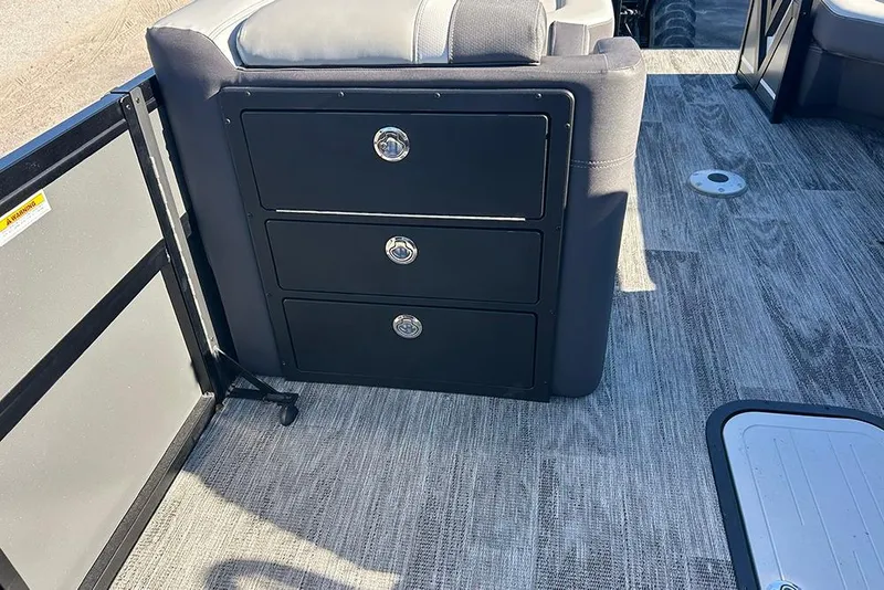 Slide: The Image of 2025 Viaggio Z22D boat interior with storage drawers and gray flooring. - 33