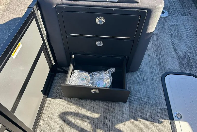 Slide: The Image of 2025 Viaggio Z22D interior with open storage drawer containing water bottles. - 34