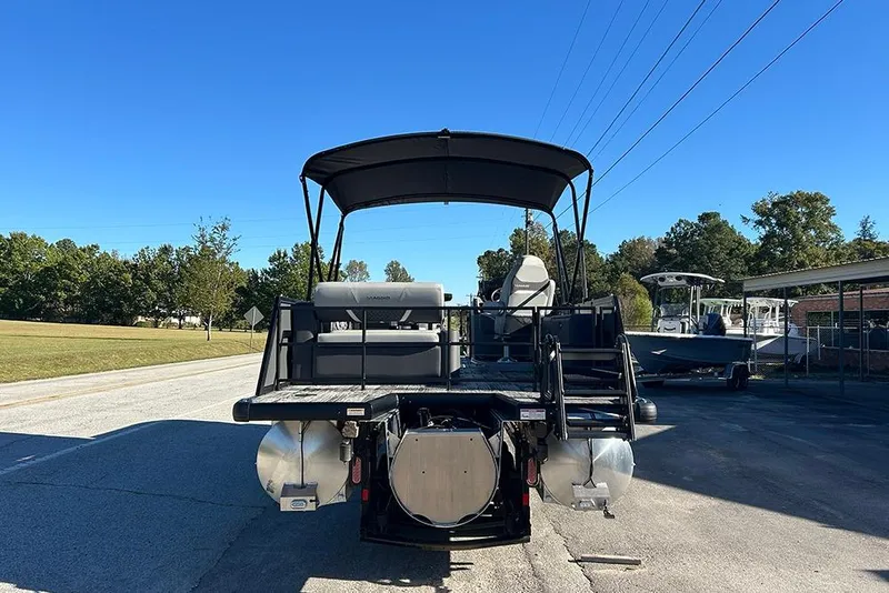 Slide: The Image of 2025 Viaggio Z22D pontoon boat on a sunny day, parked on a road. - 6