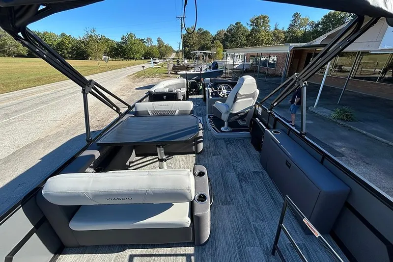 Slide: The Image of 2025 Viaggio Z22D pontoon boat interior with seating and steering console. - 9