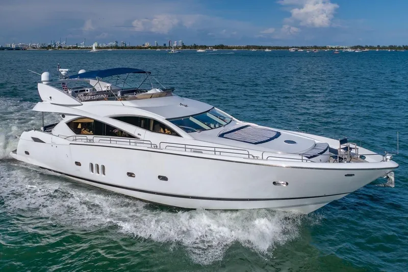 The Image of 2003 Sunseeker 82 Yacht cruising on open water under clear skies. - 1