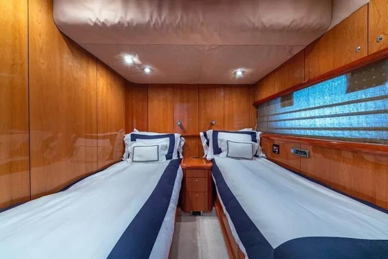 Slide: The Image of Luxurious twin cabin interior on 2003 Sunseeker 82 Yacht with wood paneling and modern lighting. - 14