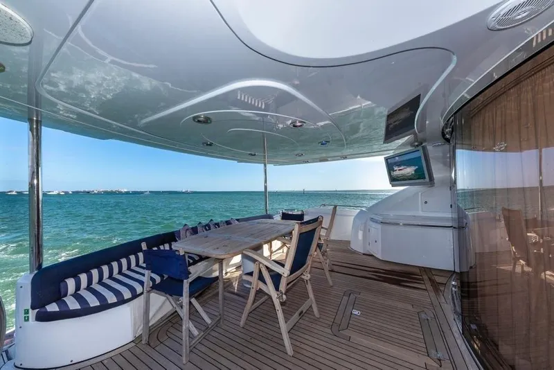 Slide: The Image of Luxurious Sunseeker 82 Yacht deck with ocean view, featuring elegant seating and dining area. - 3