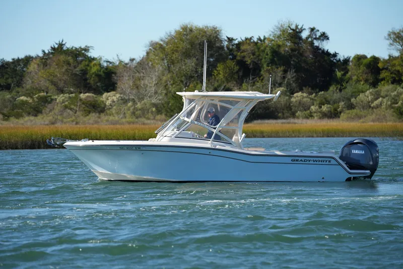 Slide: The Image of 2022 Grady-White Freedom 235 boat cruising on a scenic waterway. - 10