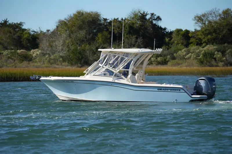 Slide: The Image of 2022 Grady-White Freedom 235 boat cruising on a scenic waterway. - 11