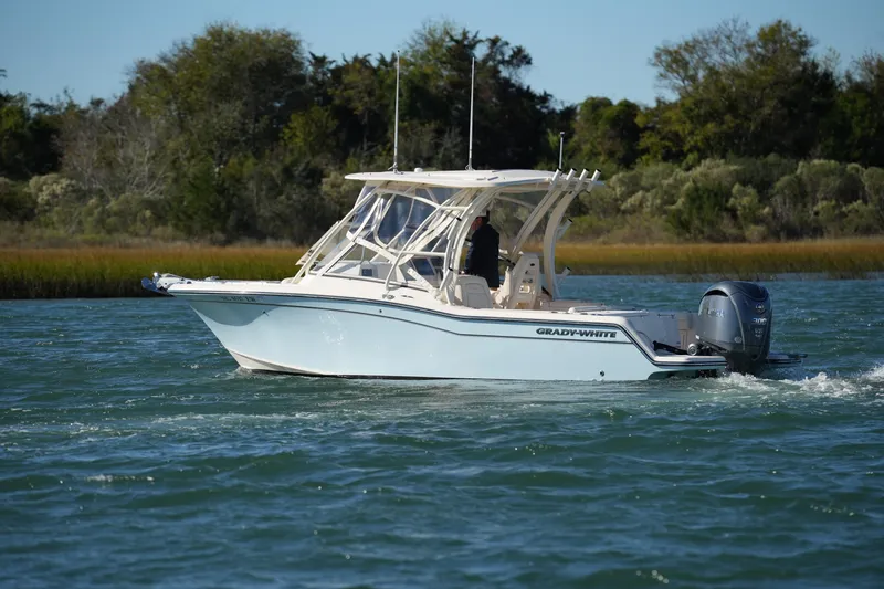 Slide: The Image of 2022 Grady-White Freedom 235 boat cruising on a scenic waterway. - 12