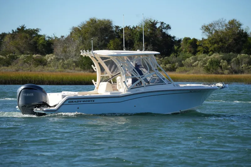 Slide: The Image of 2022 Grady-White Freedom 235 boat cruising on a scenic waterway. - 15