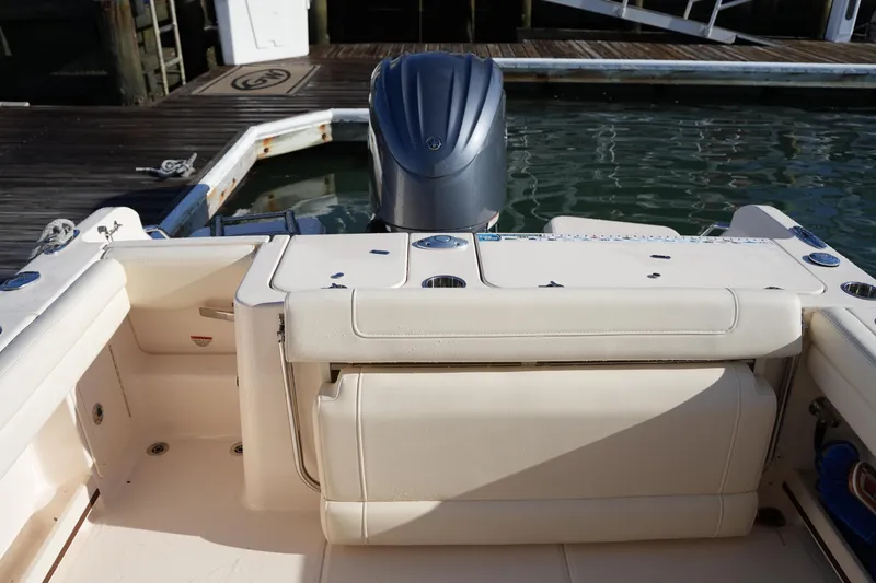 Slide: The Image of 2022 Grady-White Freedom 235 boat interior with engine, docked at marina. - 17