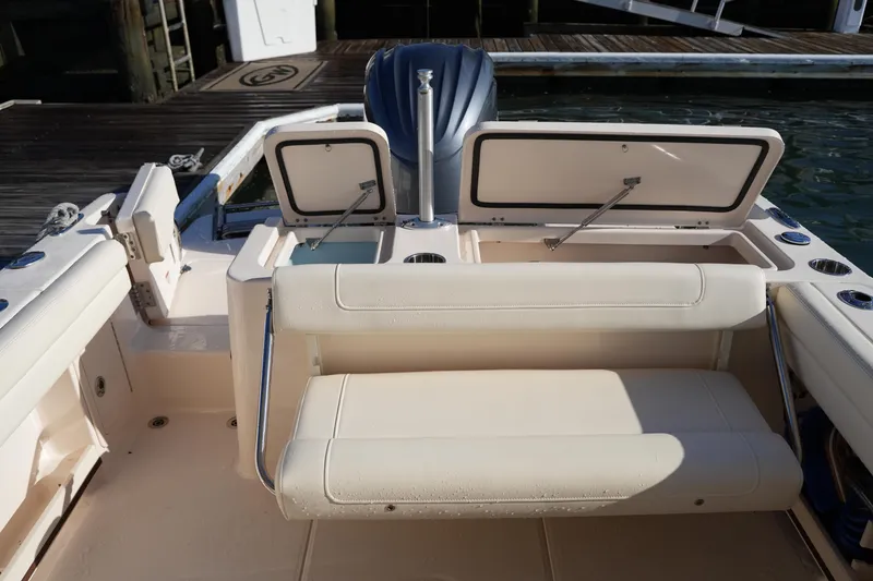 Slide: The Image of 2022 Grady-White Freedom 235 boat interior with seating and storage compartments. - 18