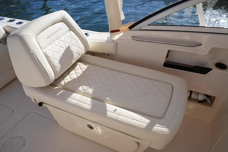 Slide: The Image of 2022 Grady-White Freedom 235 boat seat with quilted upholstery by the water. - 20