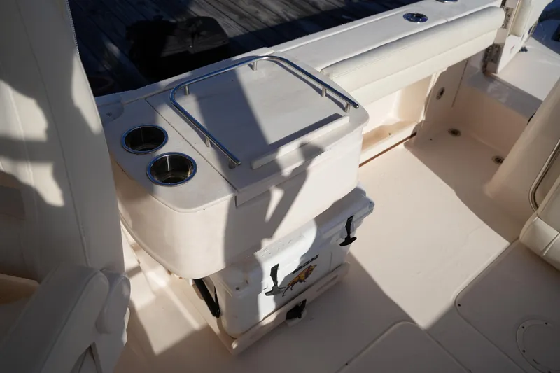 Slide: The Image of 2022 Grady-White Freedom 235 boat interior with cup holders and storage area. - 22