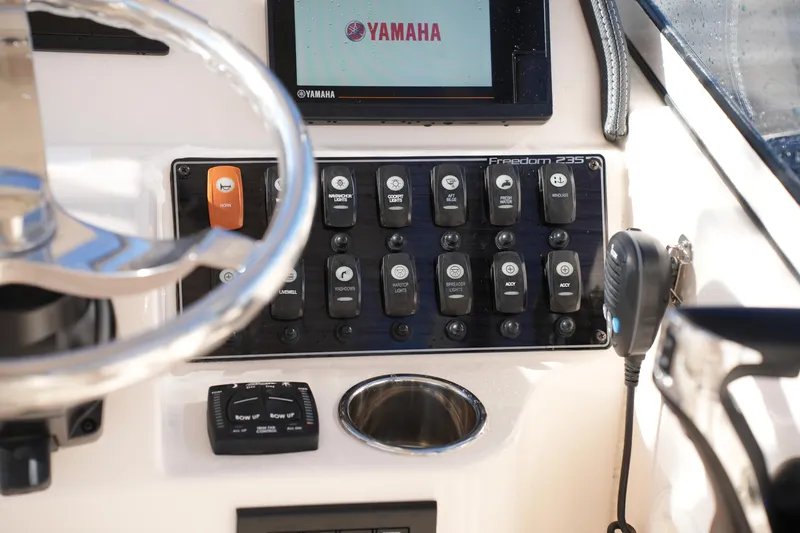 Slide: The Image of Control panel of 2022 Grady-White Freedom 235 boat with Yamaha display and switches. - 29