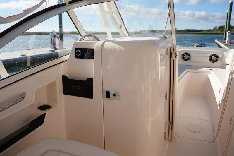Slide: The Image of 2022 Grady-White Freedom 235 boat interior with helm and seating area. - 33