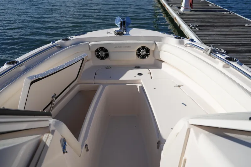 Slide: The Image of 2022 Grady-White Freedom 235 boat interior with open storage, docked by water. - 36