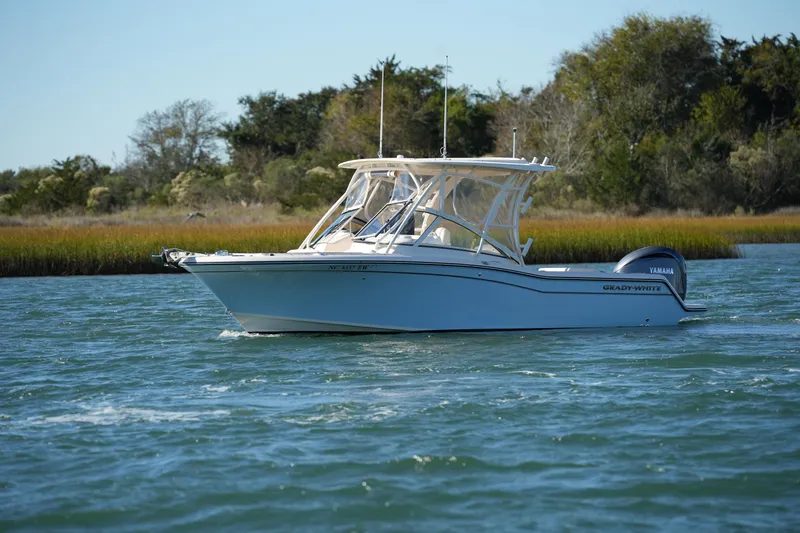 Slide: The Image of 2022 Grady-White Freedom 235 boat cruising on a scenic waterway. - 8