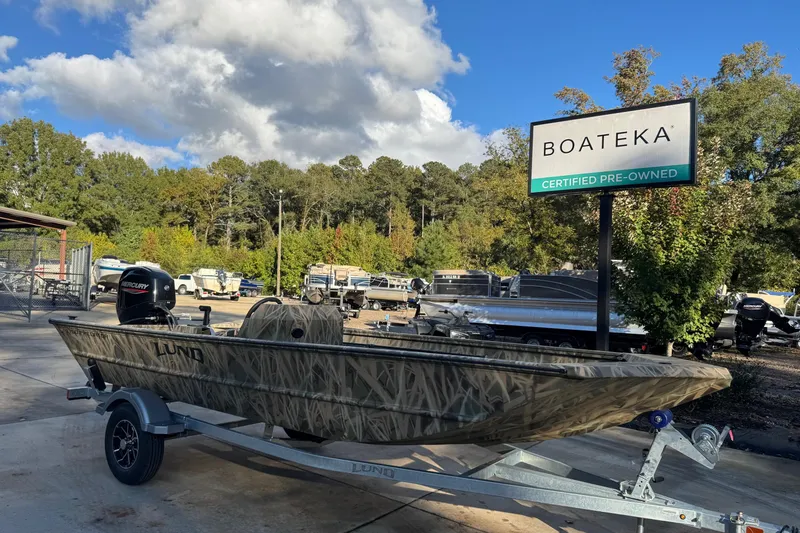 Slide: The Image of 2026 Lund 1760 Predator SC boat at Boateka, certified pre-owned, on a trailer. - 2
