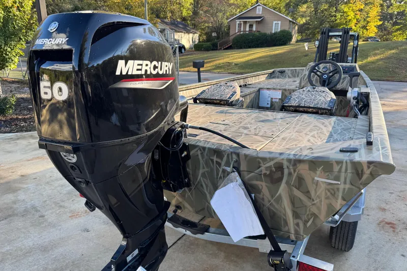 Slide: The Image of 2026 Lund 1760 Predator SC boat with Mercury 60 outboard engine, camo design. - 6