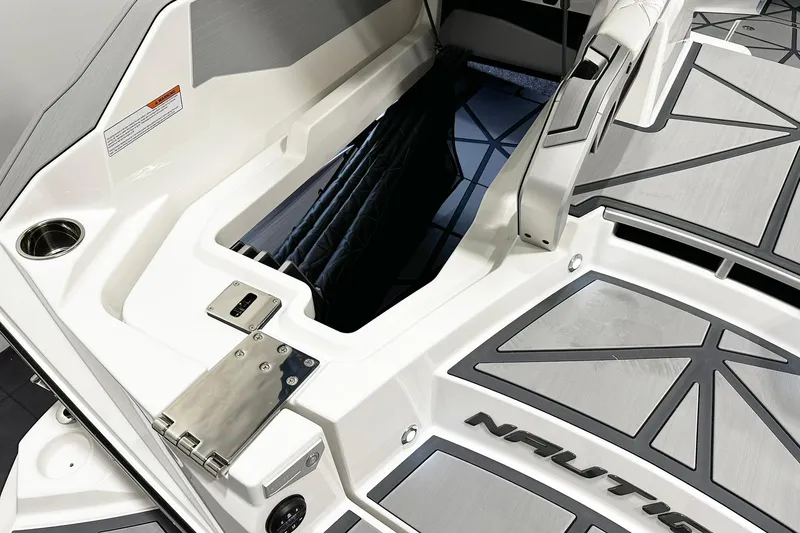 Slide: The Image of 2025 Nautique Super Air Nautique G23 Paragon boat interior with storage compartment. - 13