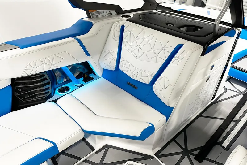 Slide: The Image of 2025 Nautique Super Air Nautique G23 Paragon interior with white and blue luxury seating. - 7