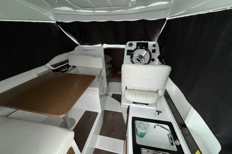 Slide: The Image of Interior of 2020 Beneteau Antares 8 boat with helm, seating, and kitchenette. - 10