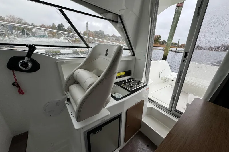 Slide: The Image of Interior of 2020 Beneteau Antares 8 boat with helm and seating area. - 12
